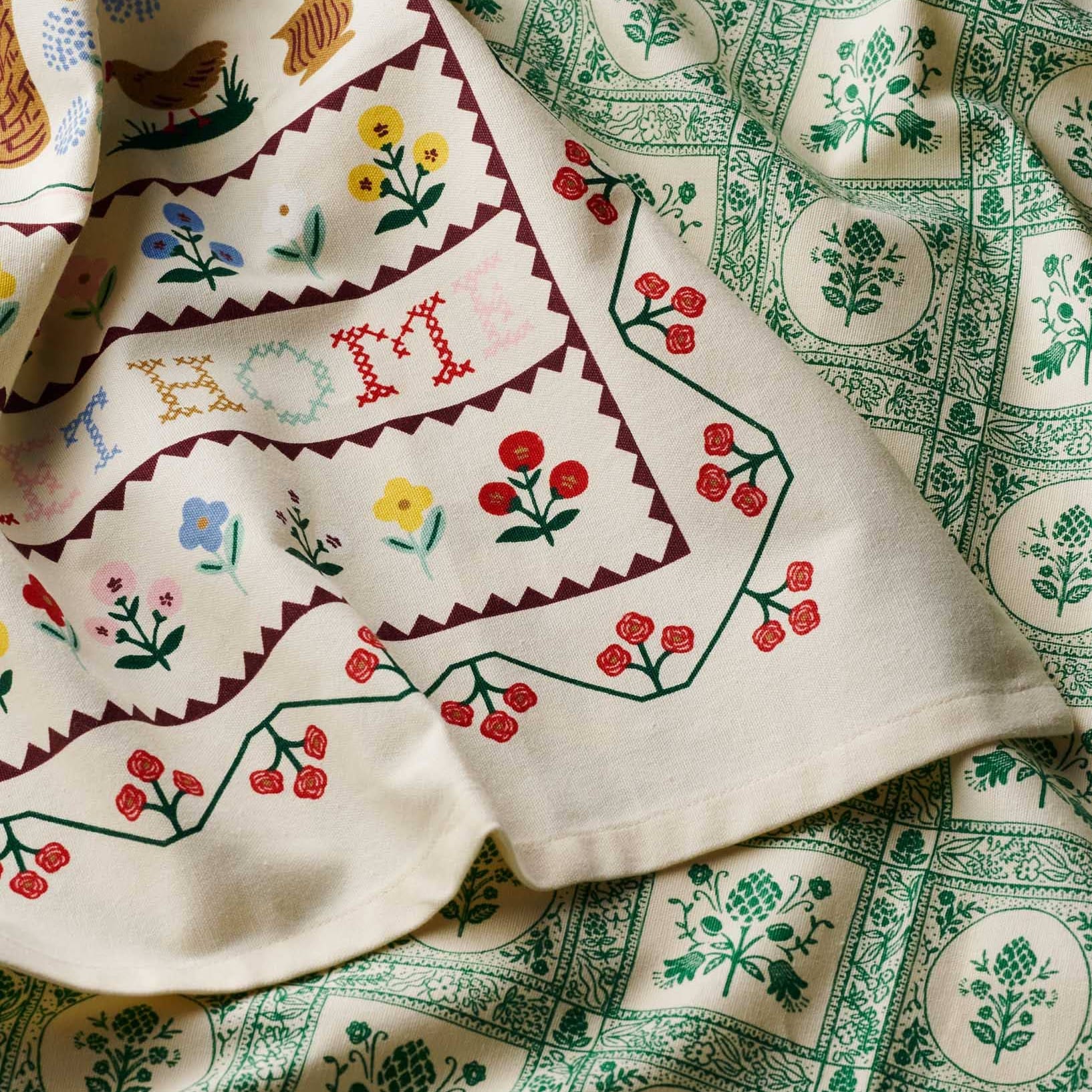 Textile with floral and geometric patterns on a green background Rifle Paper Co. Artichoke Tea Towel