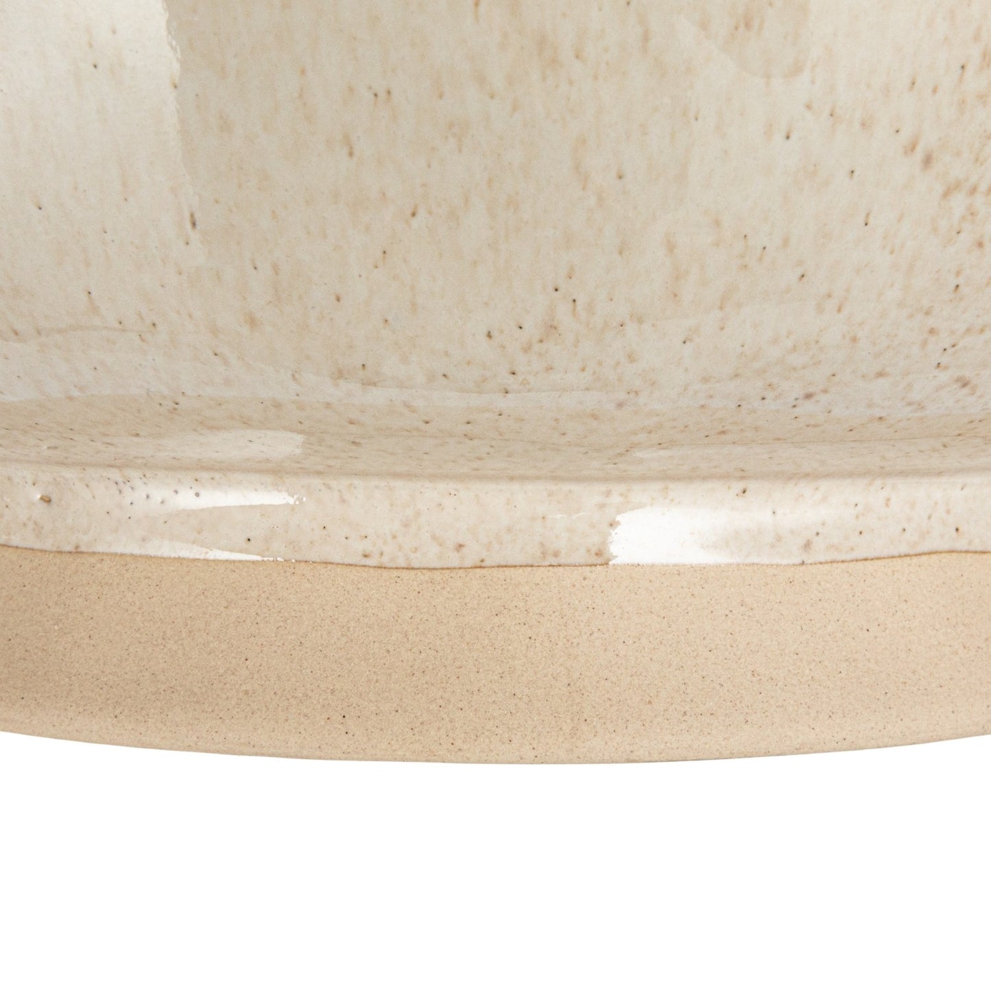 Close-up of a beige ceramic bowl with a textured surface.