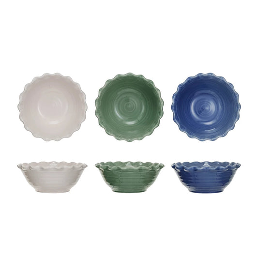 A set of stoneware bowls with scalloped edges, displayed in three colors: white, green, and blue.