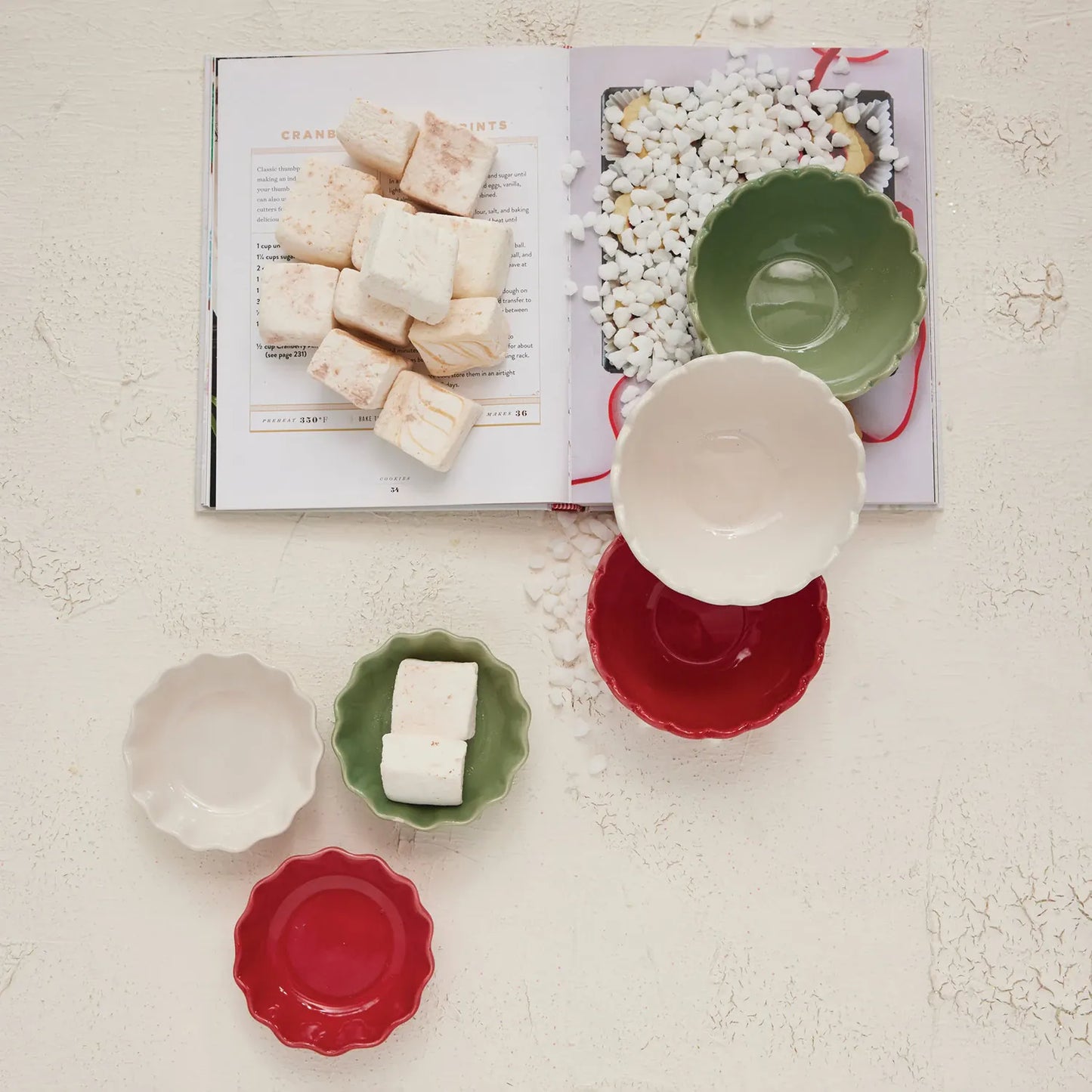 Colorful stoneware bowls next to an open book.