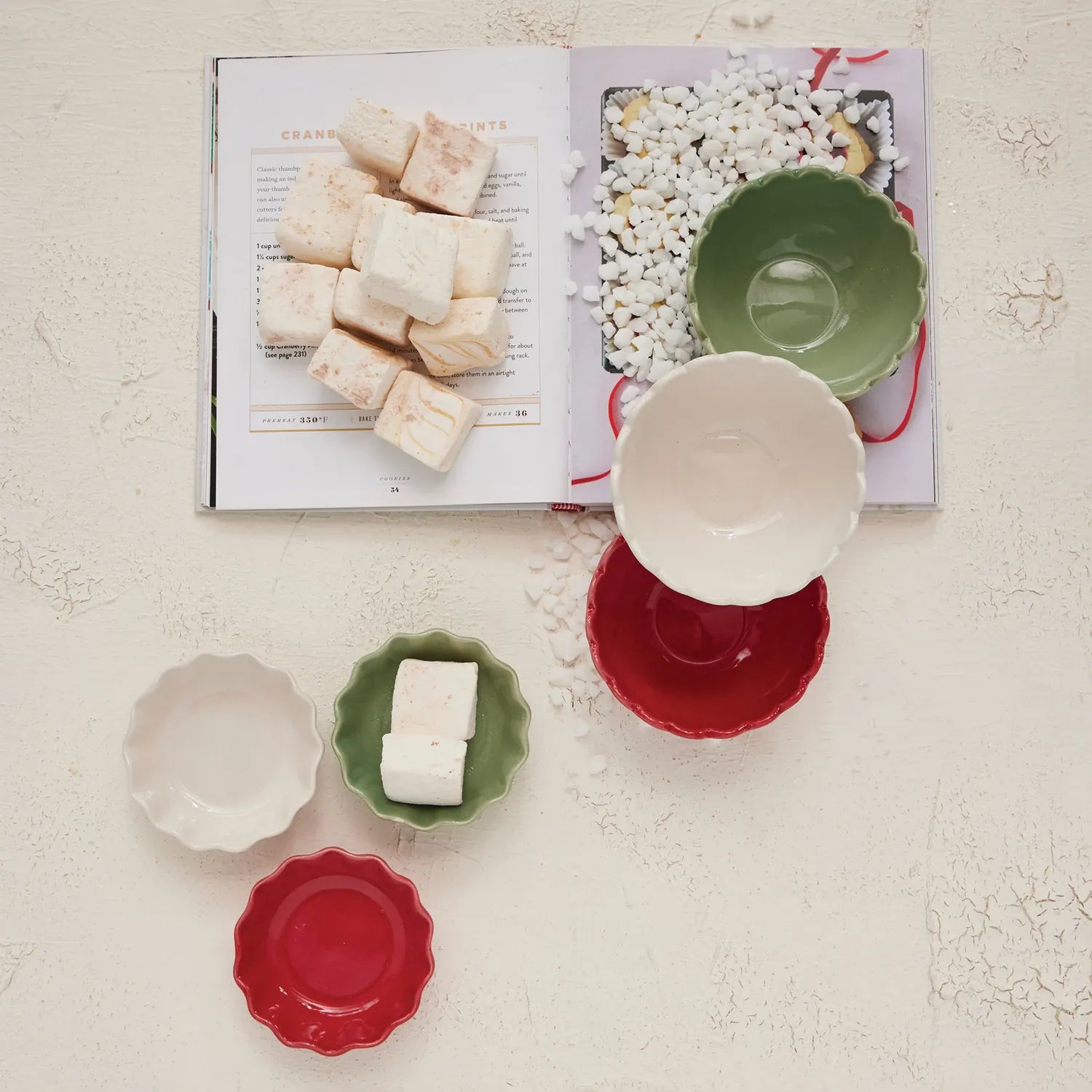 Colorful stoneware bowls next to an open book.