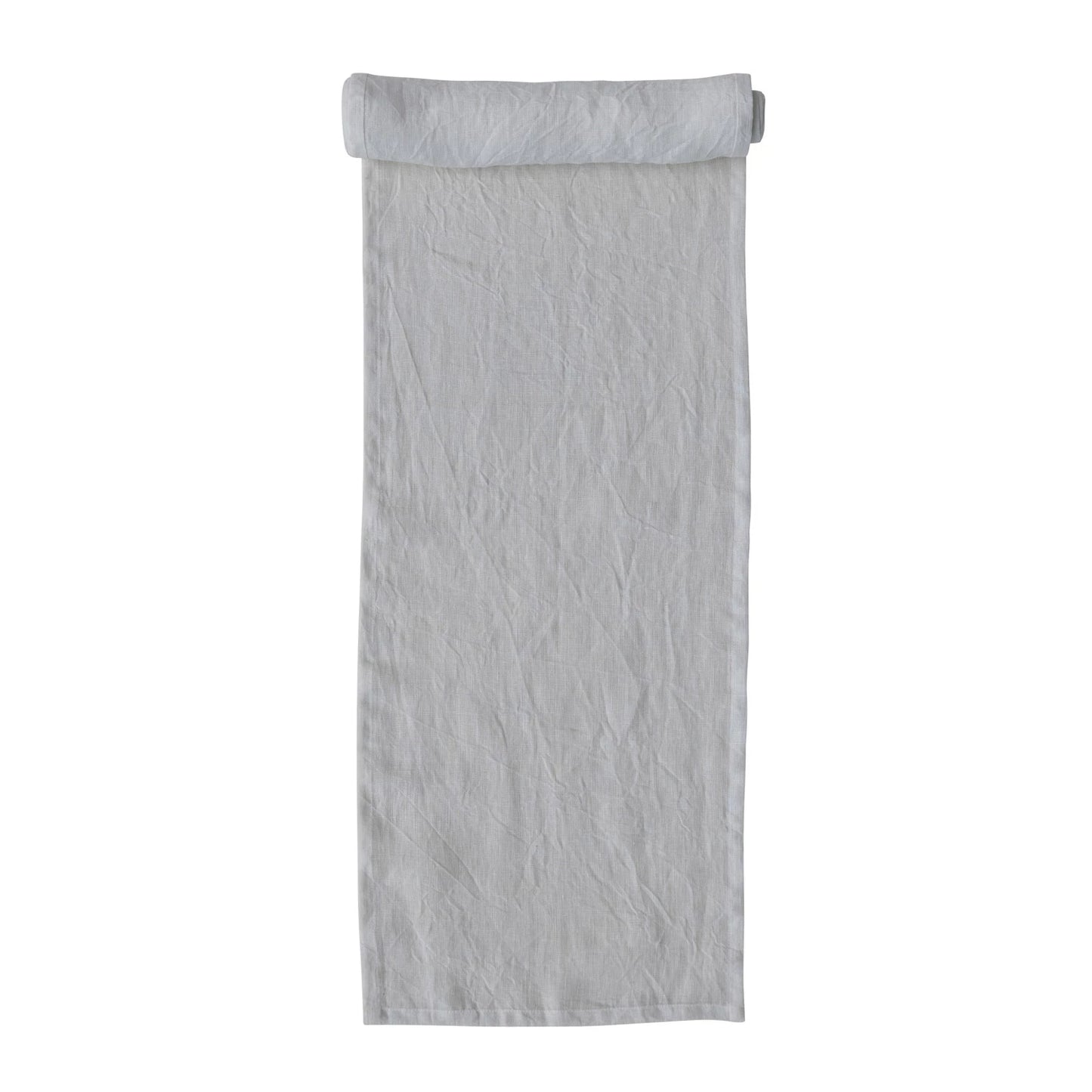 A beige linen table runner with a stonewashed texture visible.