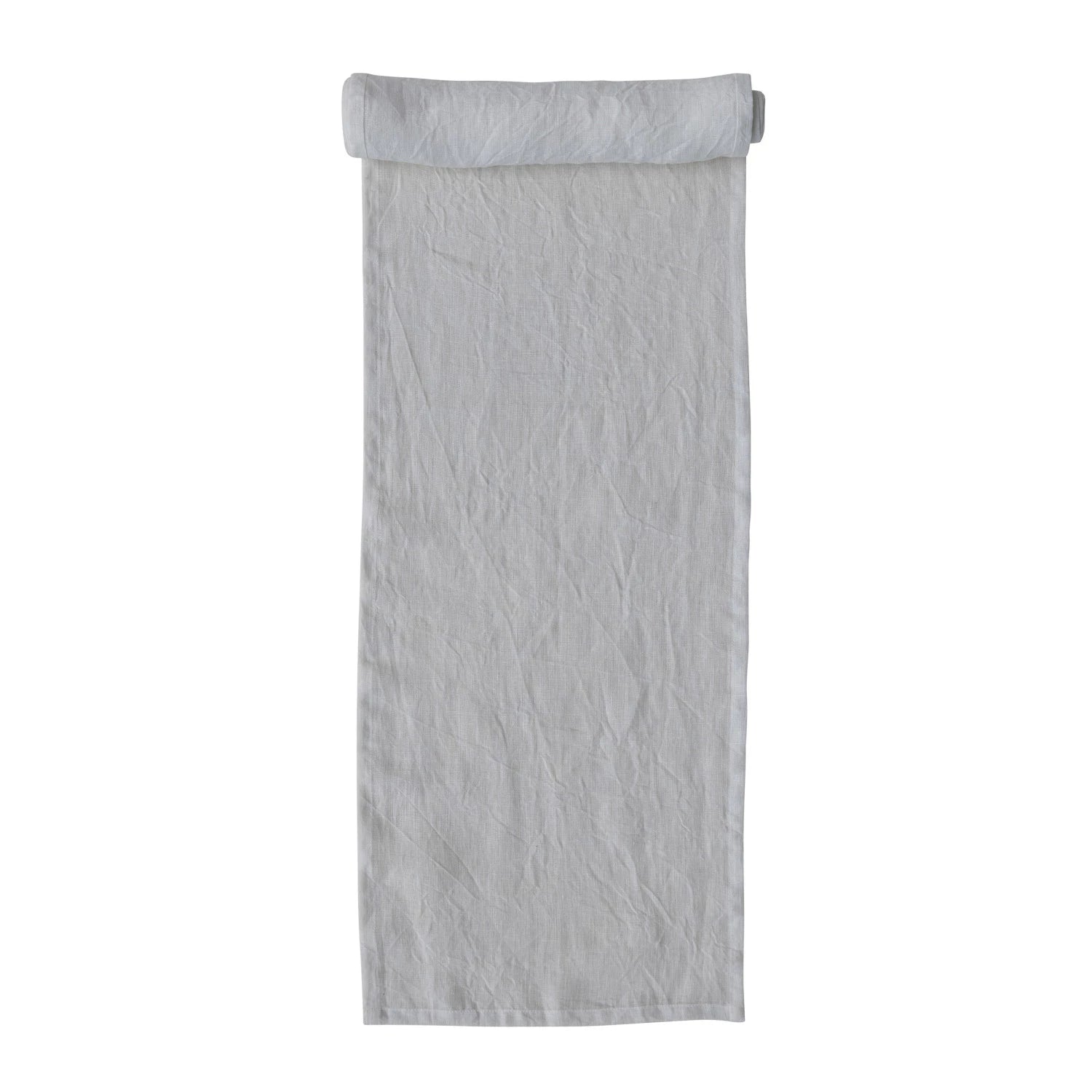 A beige linen table runner with a stonewashed texture visible.