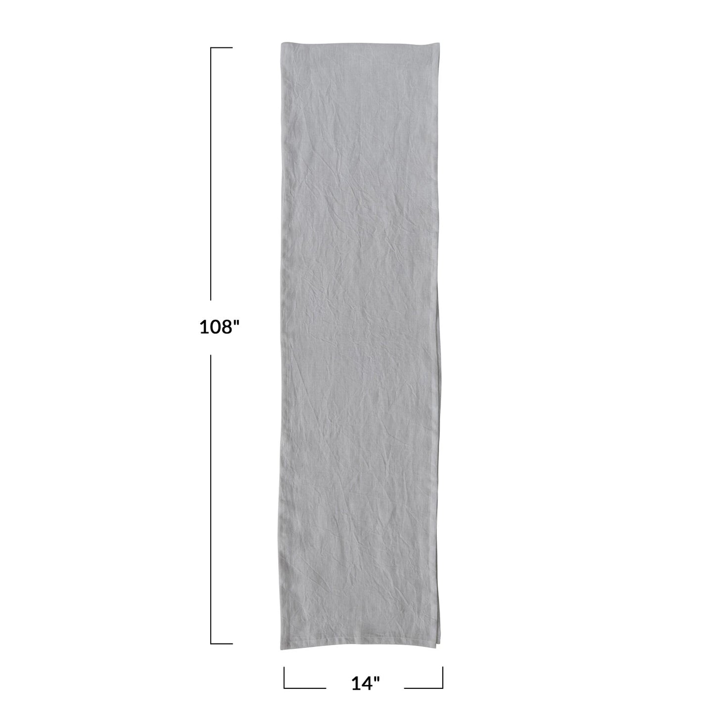 A beige linen table runner with a stonewashed texture visible.