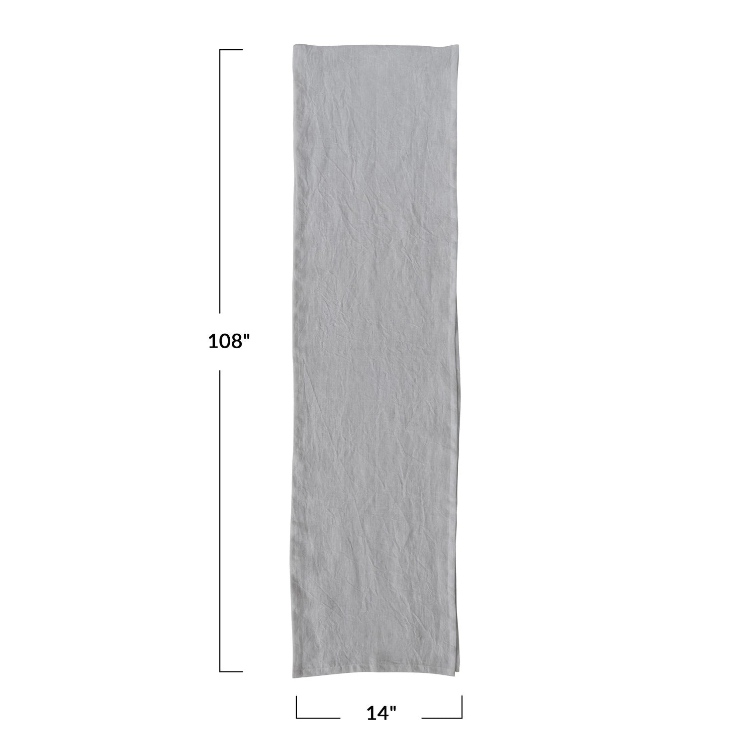 A beige linen table runner with a stonewashed texture visible.