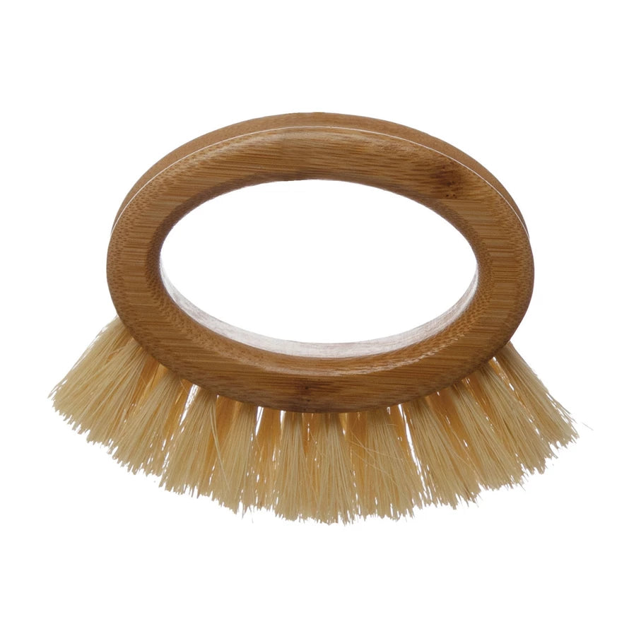 A bamboo brush with a circular handle and natural bristles, primarily beige in color.