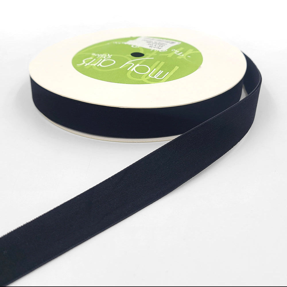 A roll of 3/4 inch velvet ribbon with a woven edge, displayed in black color.