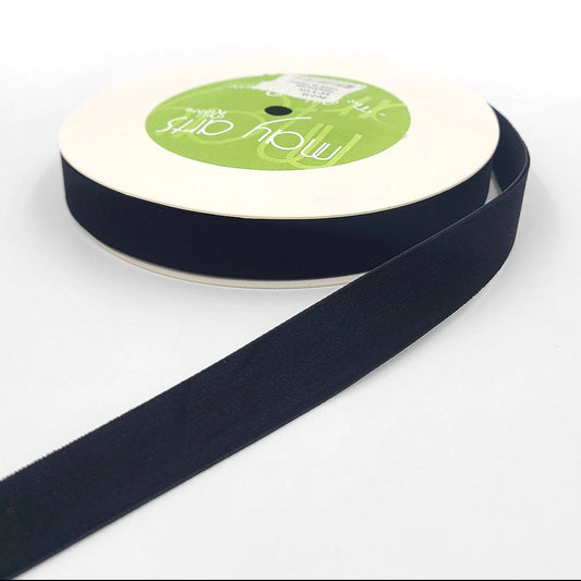 A roll of 3/4 inch velvet ribbon with a woven edge, displayed in black color.