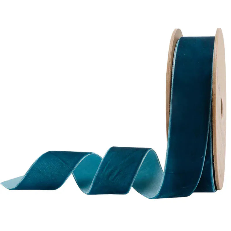 Roll of teal ribbon with a white background
