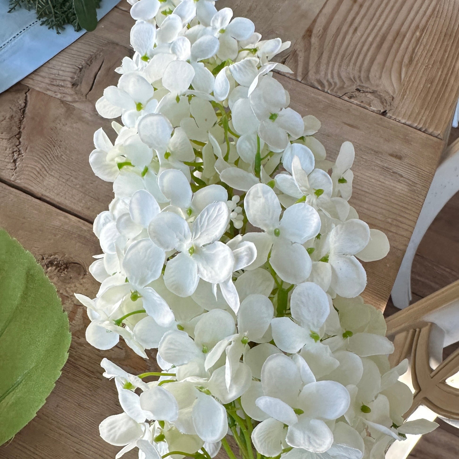 White hydrangea flowers on a wooden surface