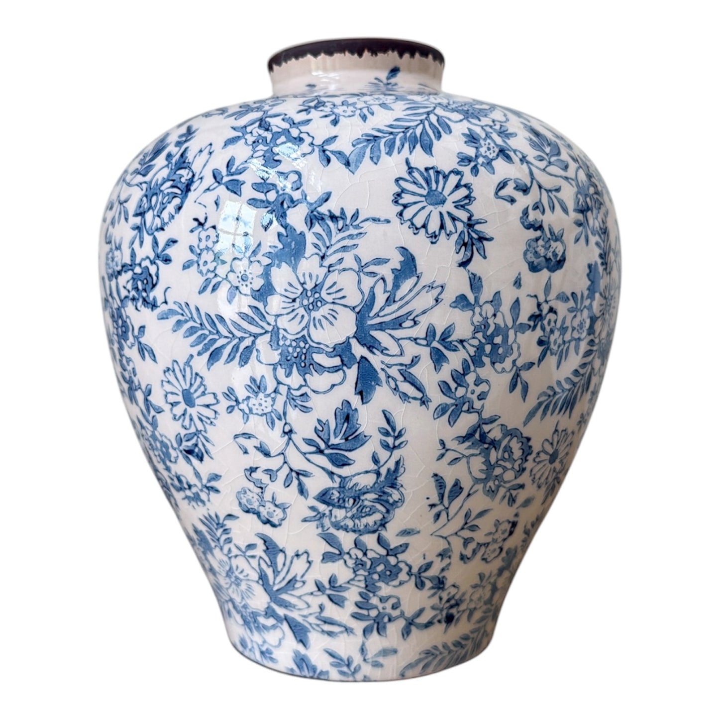Ceramic vase with blue floral pattern on a white background