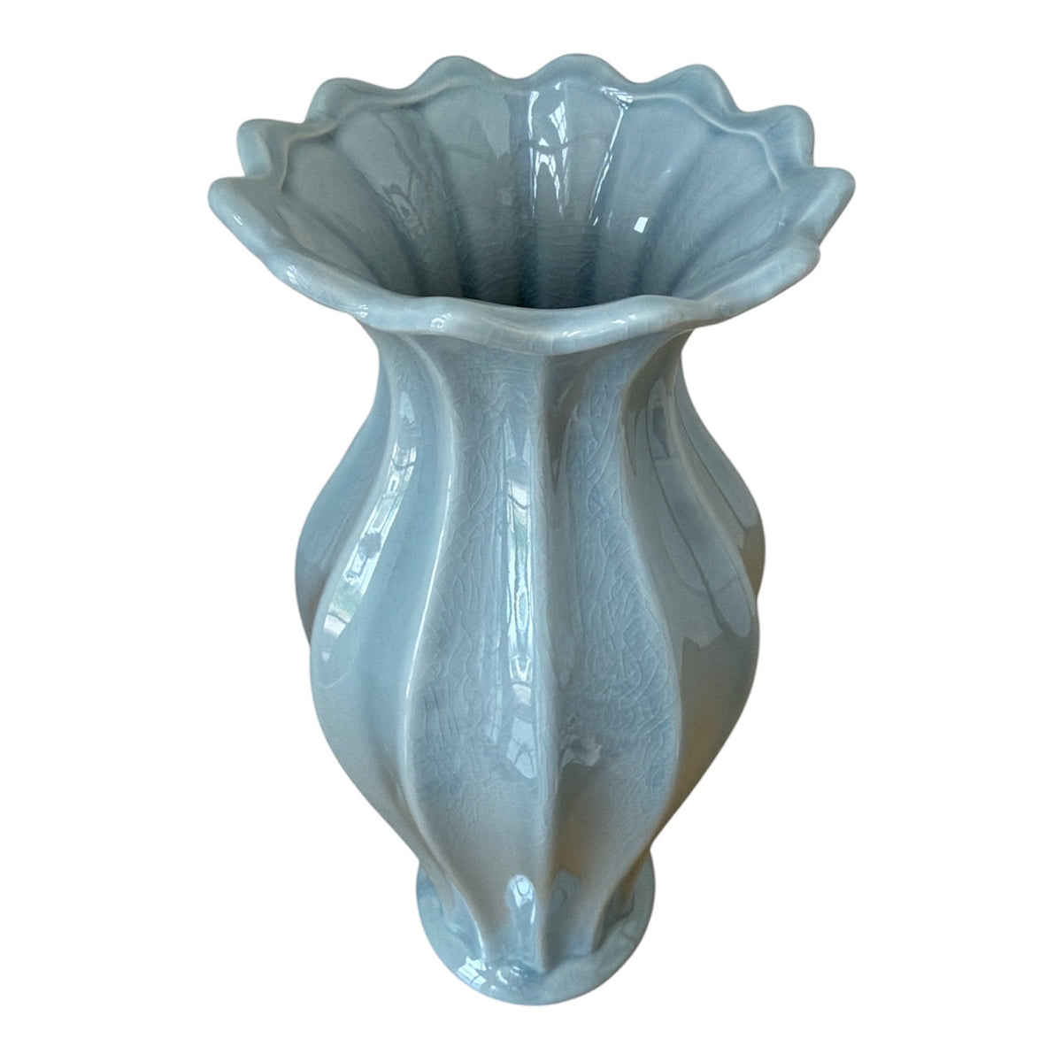 Light blue ceramic vase with decorative design on a white background