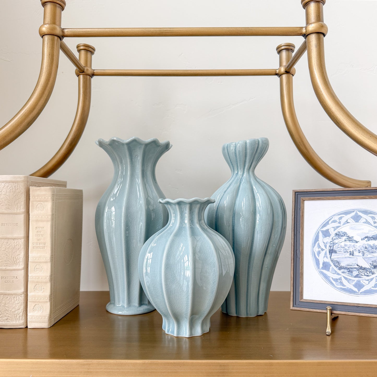 Three light blue ceramic vases