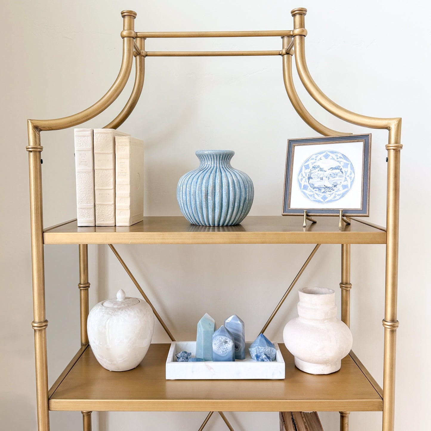 light blue ribbed fluted 7.75 inch ceramic vase on a gold shelf