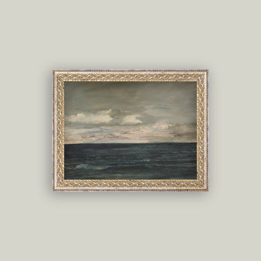 Framed painting of a seascape with a cloudy sky on a light gray wall.