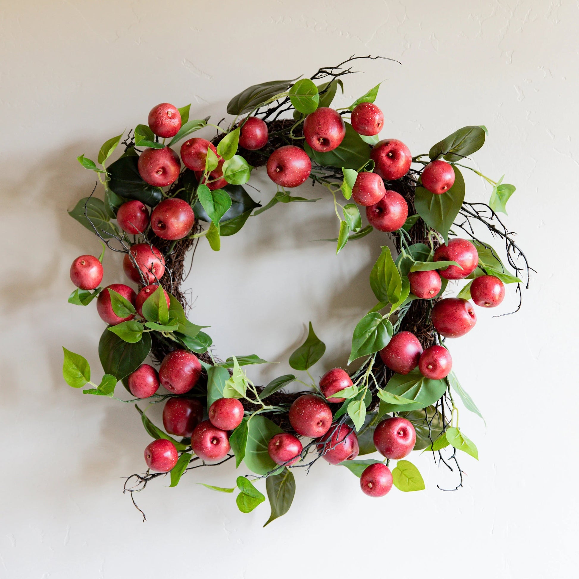24 INCH RED APPLE AND TWIG W/FOLIAGE WREATH ON GRAPEVINE BASE